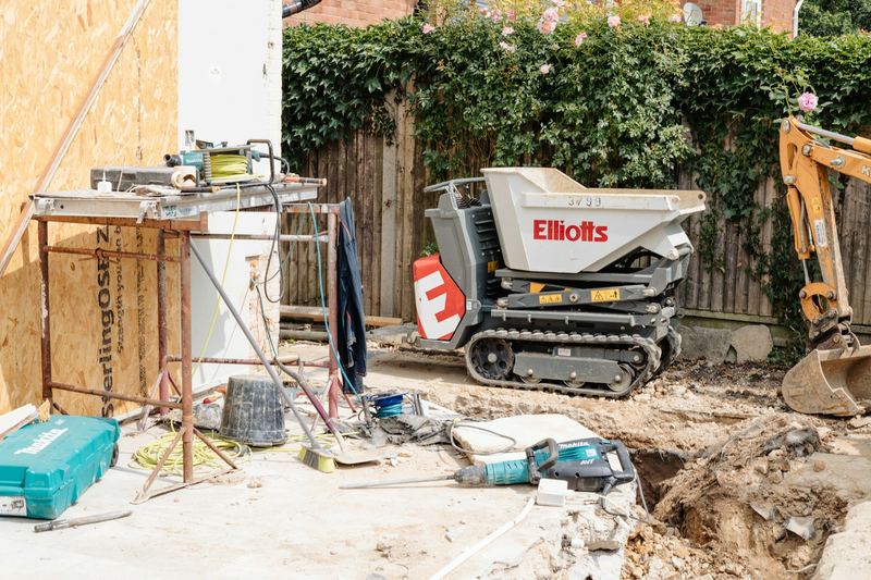 Mini dumper and excavator on a residential excavation site