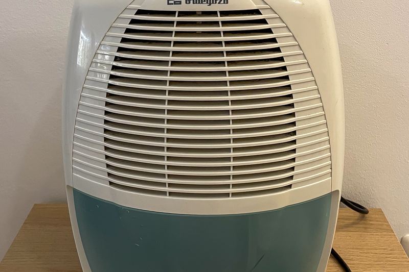 Portable dehumidifier used to control damp air in a basement or cellar